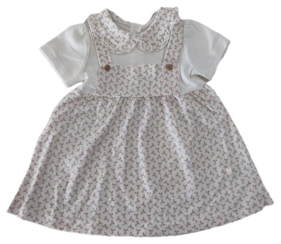 Floral pinafore dress over white collared blouse