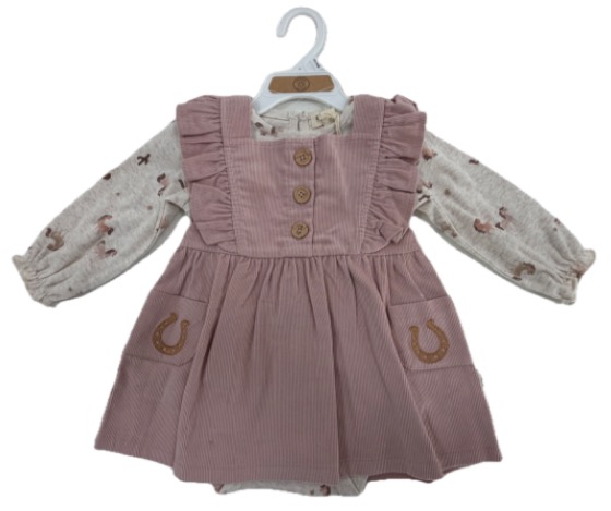 Pink corduroy pinafore dress over printed bodysuit on hanger